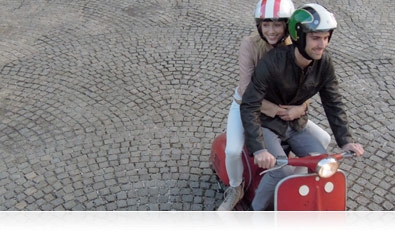 Fast-action photo of a couple riding a motor scooter in New Orleans, Louisiana 