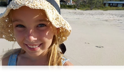 close up portrait of a girl on the beach, looking into the camera highlighting the Smart Portrait System