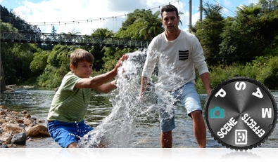 Photo of a dad and son having fun at the lake's edge