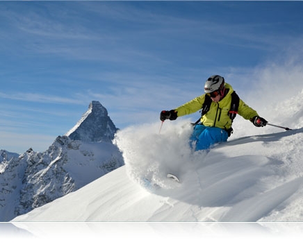 Photo of a skier going down a mountain in powder showing fast AF speed